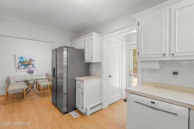a kitchen with stainless steel appliances a refrigerator and a stove top oven