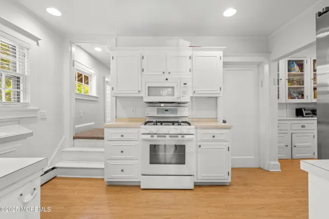 a kitchen with stainless steel appliances white cabinets and a stove