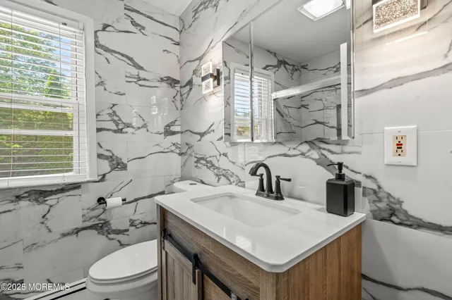 a bathroom with a sink a toilet and shower curtain