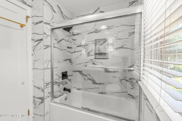 a bathroom with a bathtub and shower