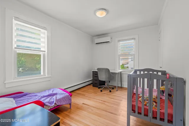 a bedroom with furniture and a window