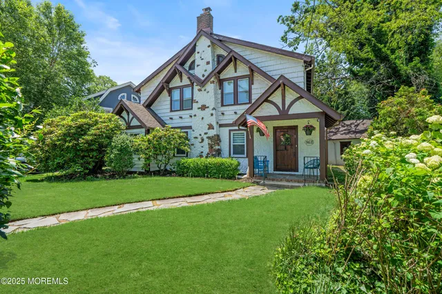 a front view of a house with a yard and porch