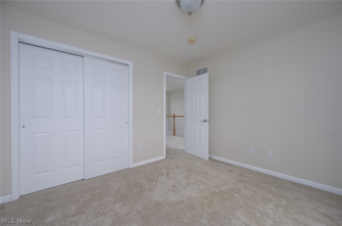 1060 Susan Road Ravenna, OH 44266 - Photo 13 of 25 Sizable bedroom featuring light carpet and a closet