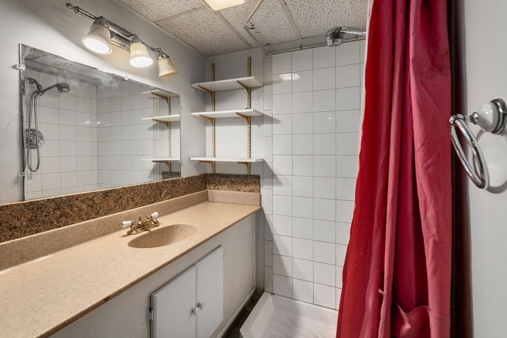 14 Channing Street Worcester, MA 01605 - Photo 11 of 16 a bathroom with a sink and a mirror