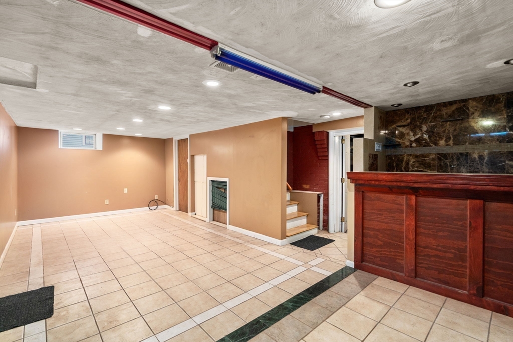 14 Channing Street Worcester, MA 01605 - Photo 13 of 16 a spacious bedroom with a bed and a dresser