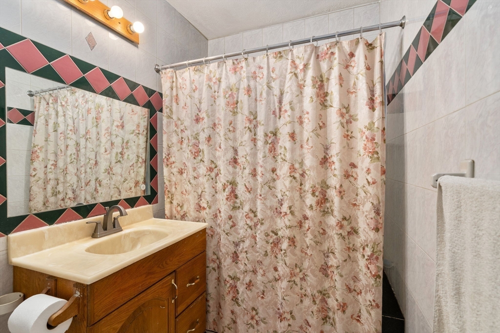 14 Channing Street Worcester, MA 01605 - Photo 6 of 16 a bathroom with a sink and a mirror