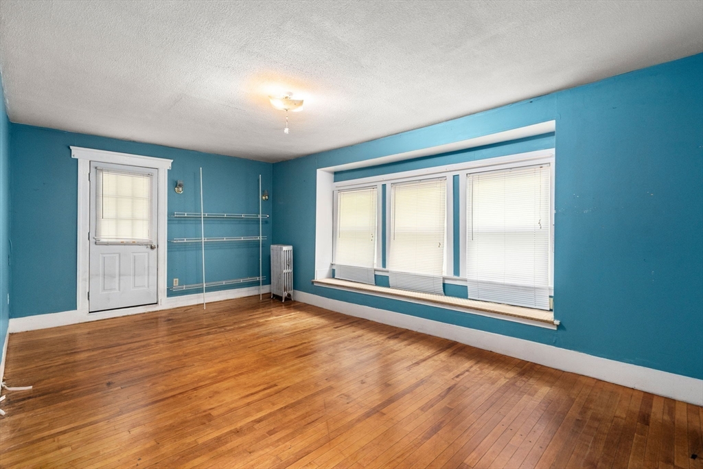 14 Channing Street Worcester, MA 01605 - Photo 9 of 16 an empty room with wooden floor and windows