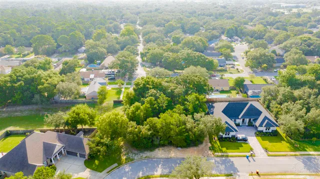 a aerial view of a house with swimming pool and garden