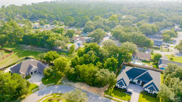 an aerial view of residential house with yard and swimming pool