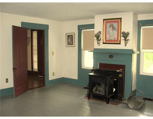 254 Cushman Road Winslow, ME 04901 - Photo 5 of 23 Living Room. Gas stove in living room.