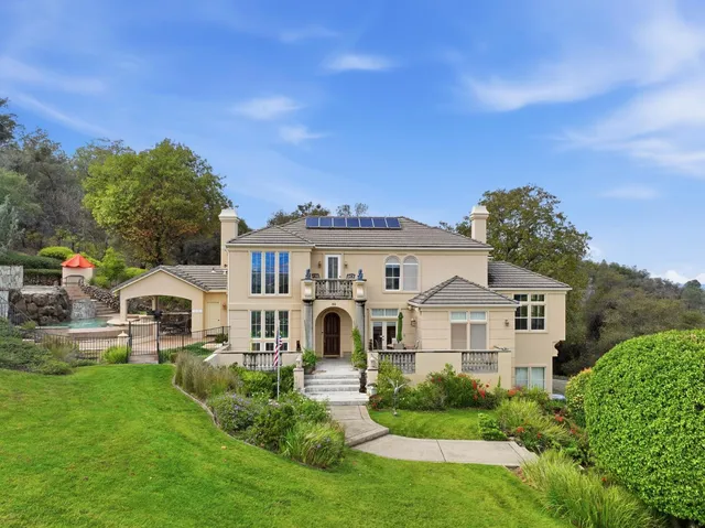 a view of a livingroom with furniture wooden floor and a chandelier