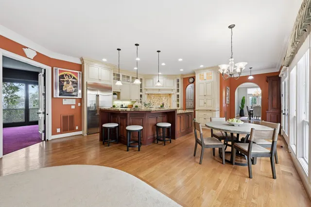 a view of a hallway with wooden floor and stairs