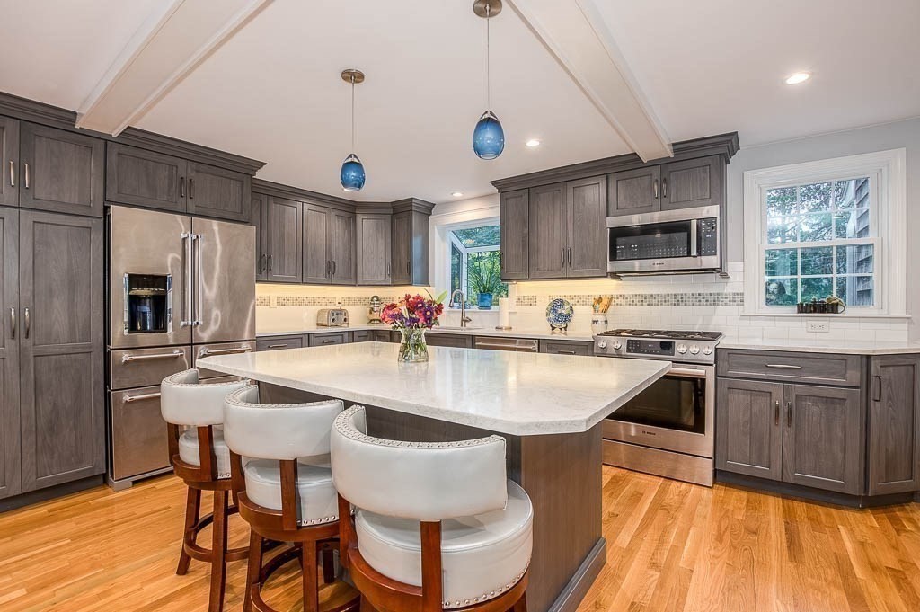 1 Intervale Road Dedham, MA 02026 - Photo 12 of 42 a kitchen with kitchen island a large counter top space appliances and cabinets