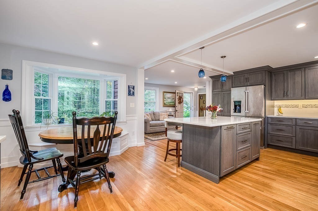 1 Intervale Road Dedham, MA 02026 - Photo 13 of 42 a kitchen with stainless steel appliances granite countertop a stove top oven a sink dishwasher and wooden cabinets with wooden floor