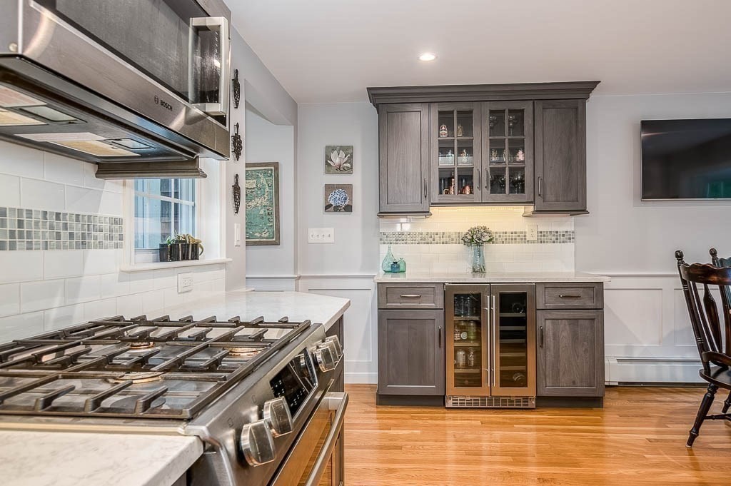 1 Intervale Road Dedham, MA 02026 - Photo 15 of 42 a kitchen with kitchen island granite countertop a stove and a sink