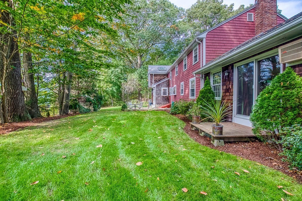 1 Intervale Road Dedham, MA 02026 - Photo 34 of 42 a front view of a house with a garden and plants