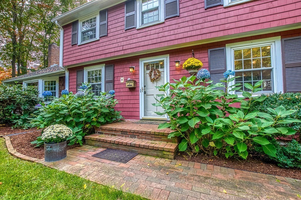 1 Intervale Road Dedham, MA 02026 - Photo 4 of 42 a front view of a house with a yard and potted plants
