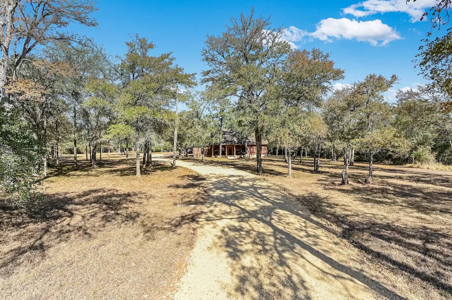 486 Westwood Road Lockhart, TX 78644 - Photo 2 of 29 View of dirt / gravel driveway featuring a view of countryside