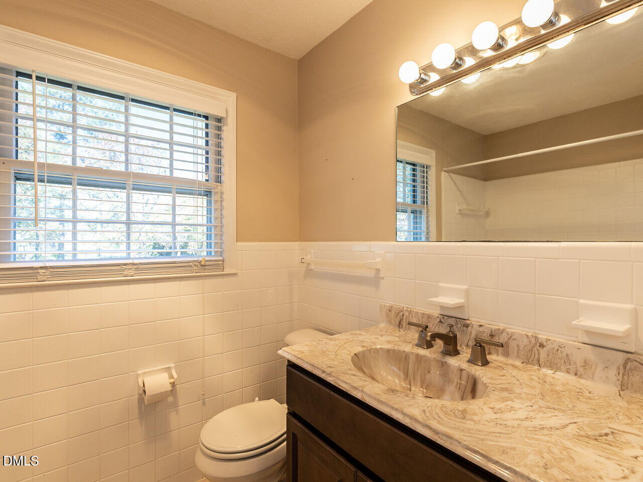 2368 Swift Creek Road Clayton, NC 27520 - Photo 17 of 31 a bathroom with a granite countertop sink toilet a mirror and shower