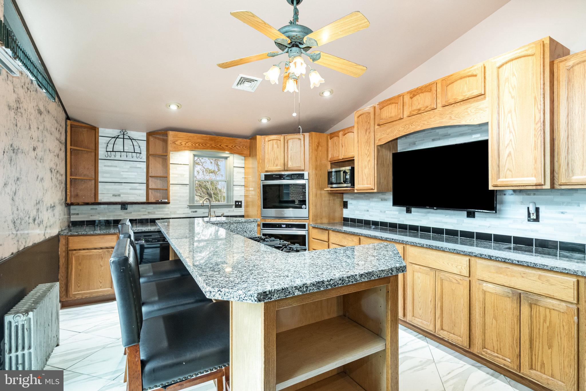 6112 Linglestown Road Harrisburg, PA 17112 - Photo 12 of 45 a kitchen with stainless steel appliances granite countertop a stove sink microwave and refrigerator