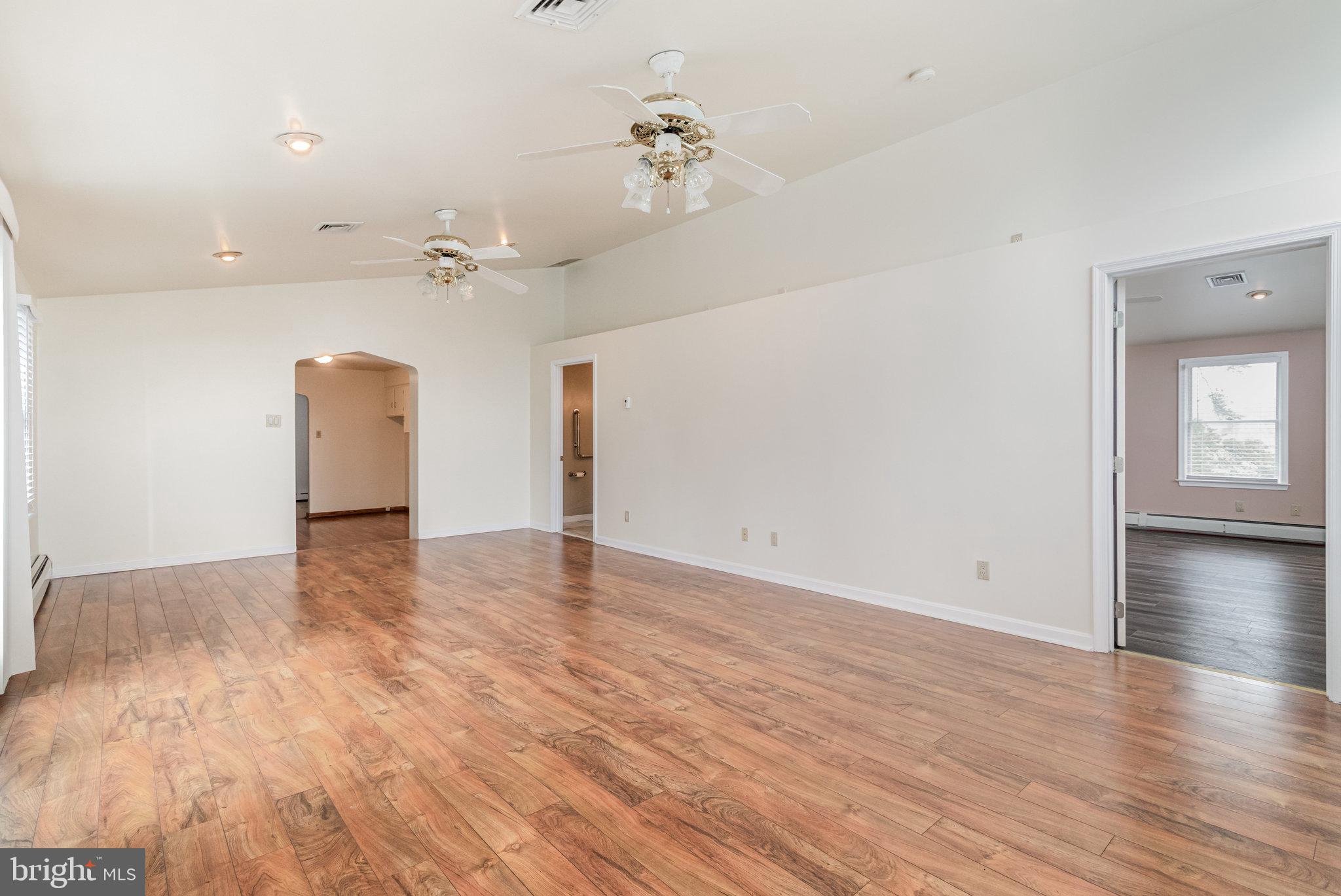 6112 Linglestown Road Harrisburg, PA 17112 - Photo 14 of 45 an empty room with wooden floor and a ceiling fan