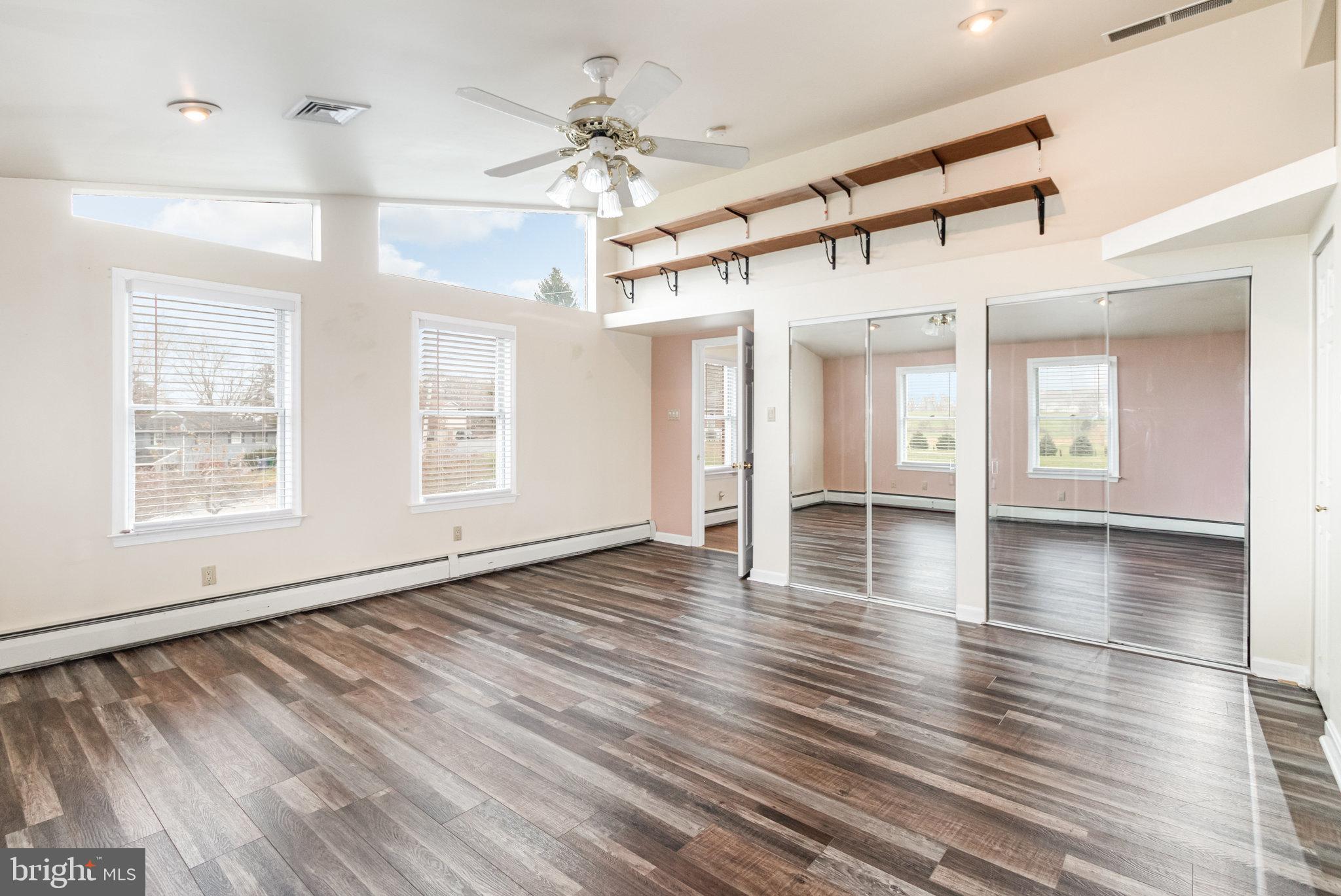 6112 Linglestown Road Harrisburg, PA 17112 - Photo 17 of 45 a view of a livingroom with wooden floor and a ceiling fan