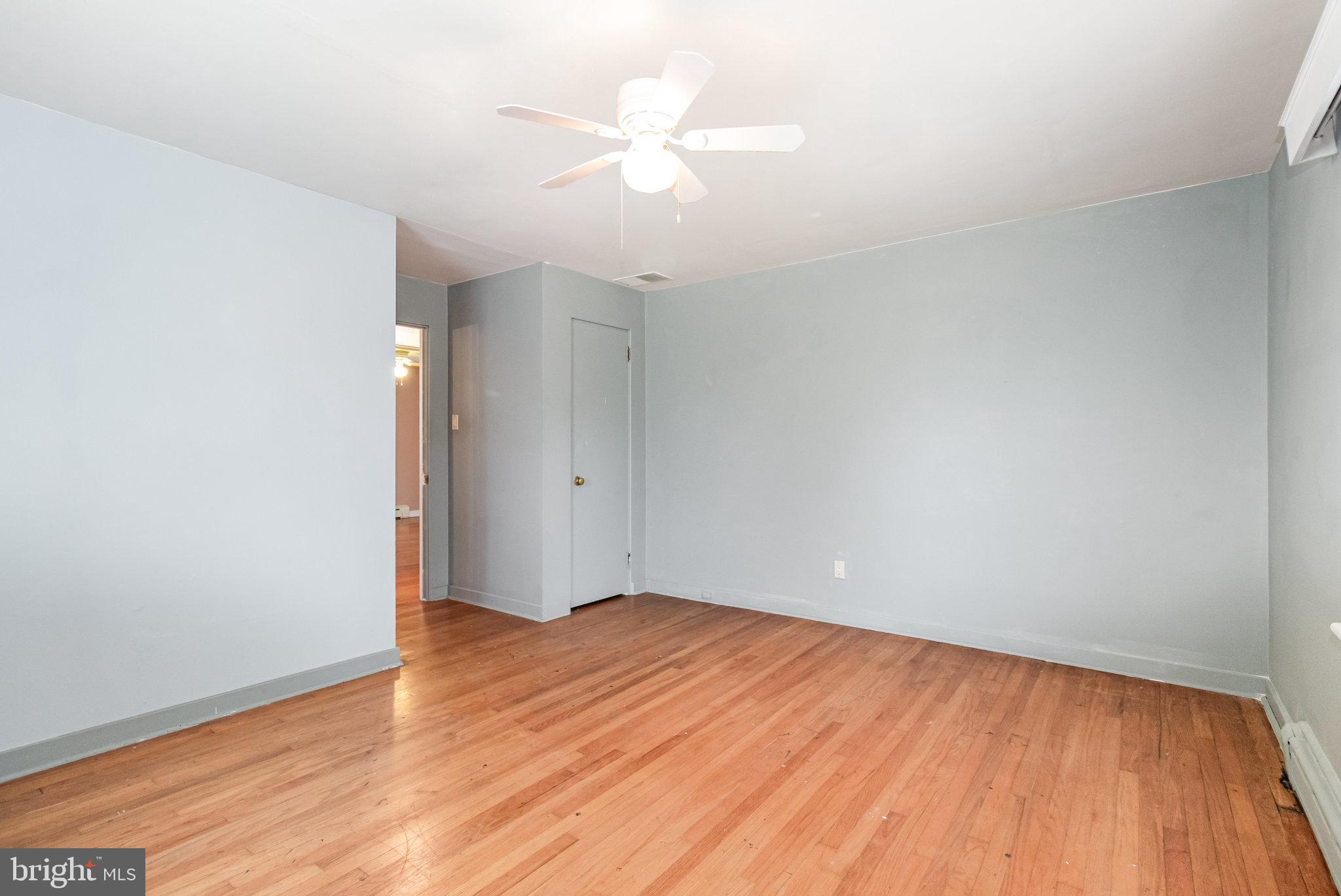 6112 Linglestown Road Harrisburg, PA 17112 - Photo 21 of 45 an empty room with wooden floor and a ceiling fan