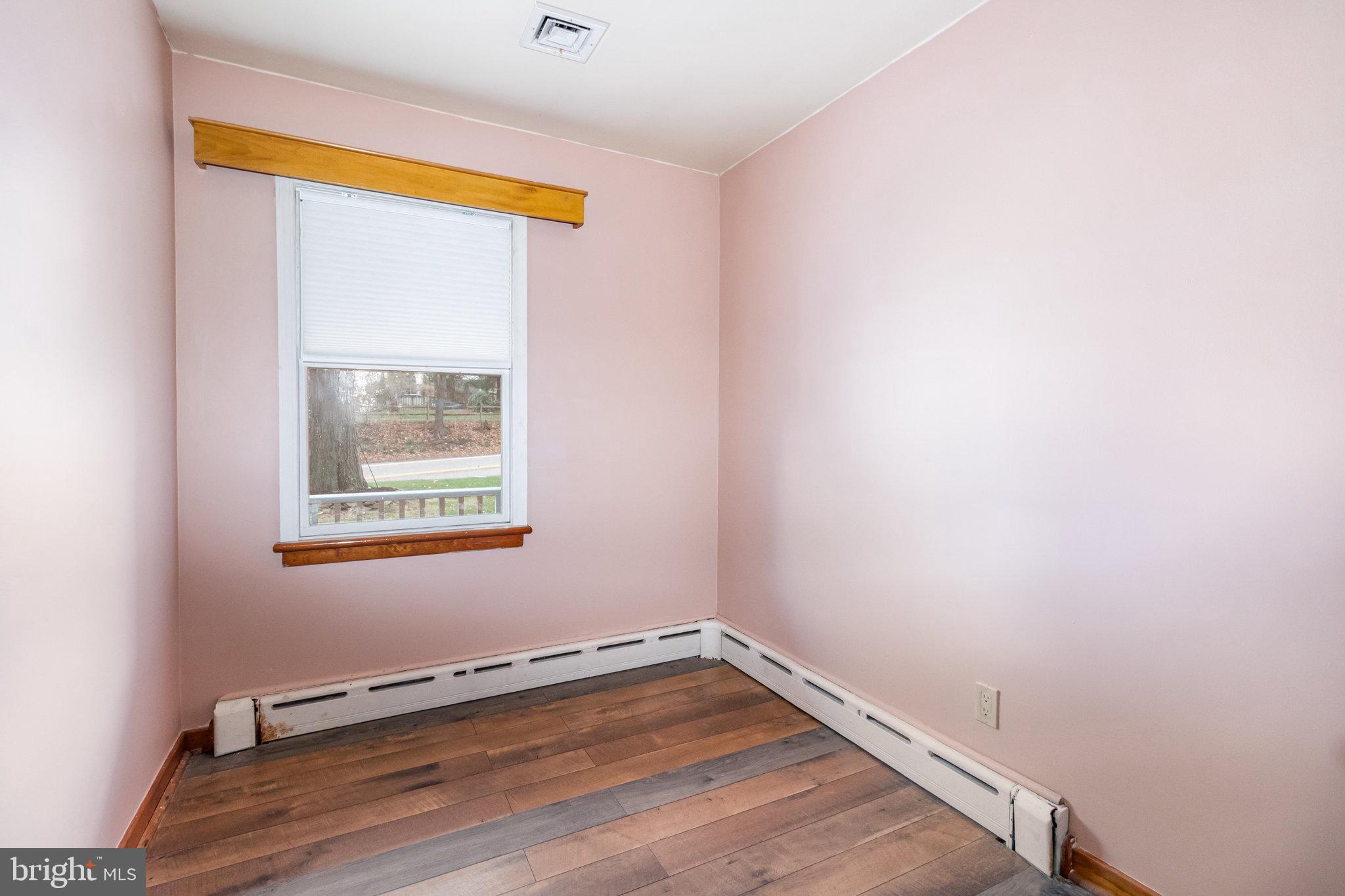 6112 Linglestown Road Harrisburg, PA 17112 - Photo 26 of 45 a view of an empty room with a window and wooden floor
