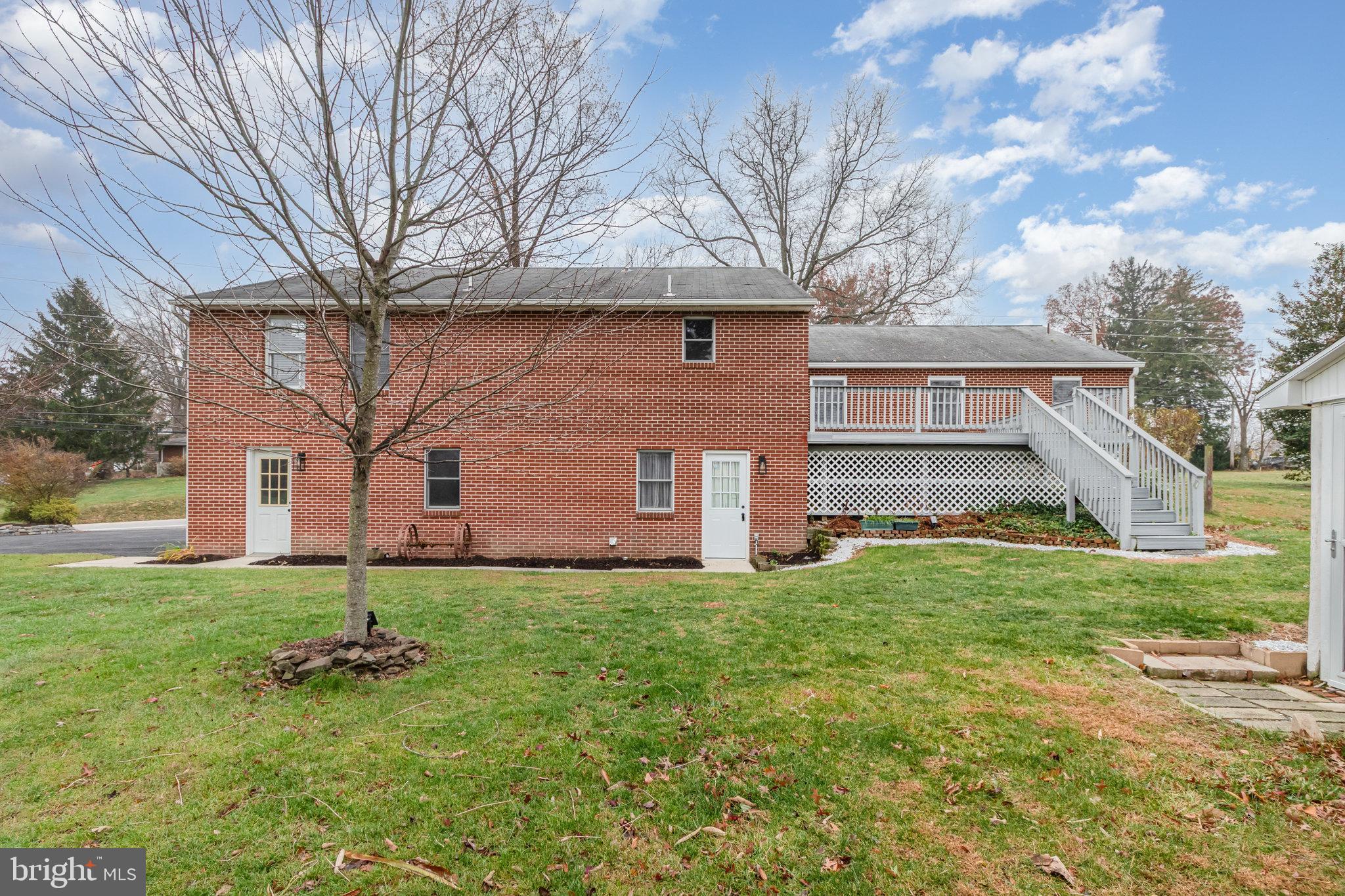 6112 Linglestown Road Harrisburg, PA 17112 - Photo 4 of 45 a backyard of a house with plants and large tree