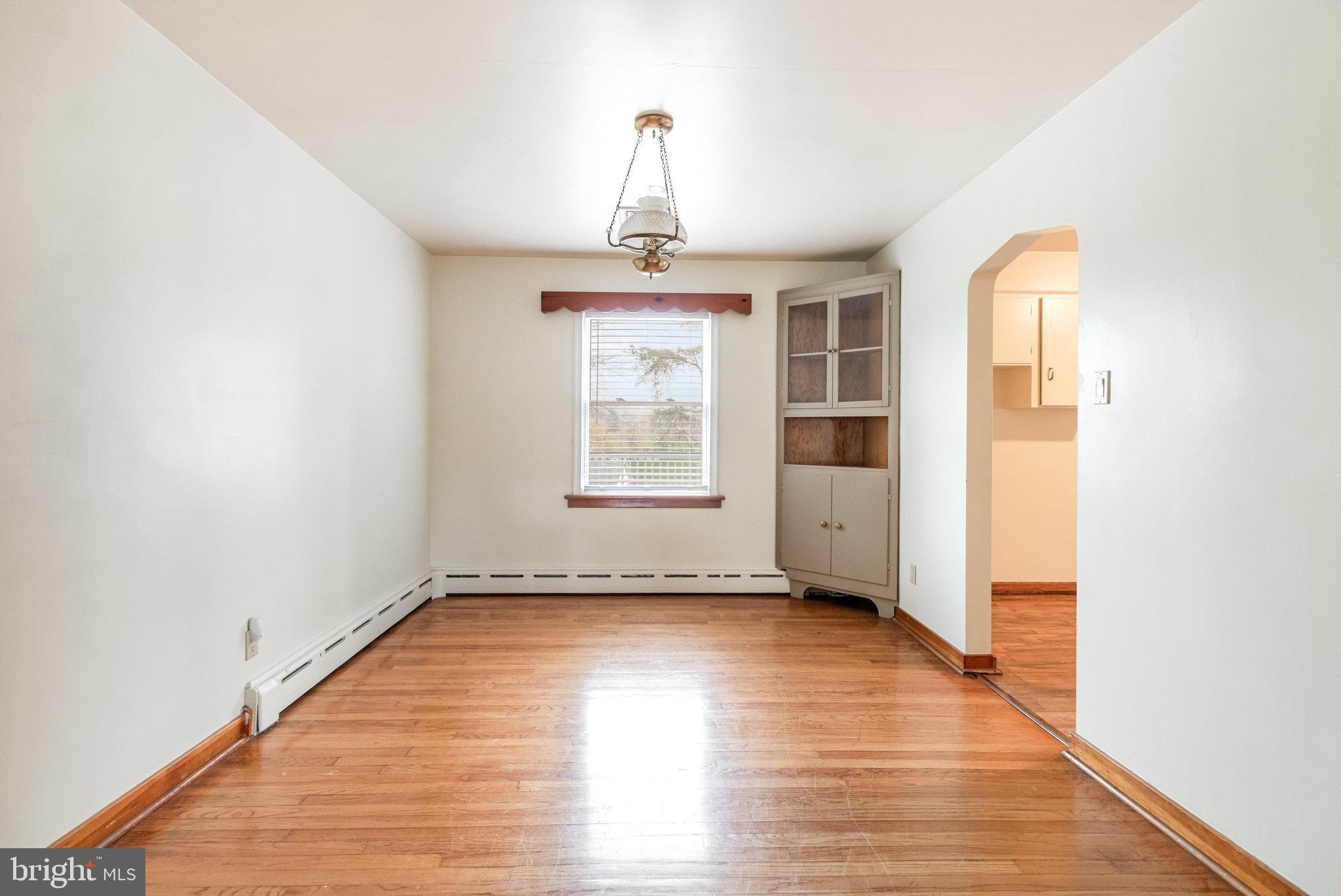 6112 Linglestown Road Harrisburg, PA 17112 - Photo 8 of 45 a view of an empty room with wooden floor and a window