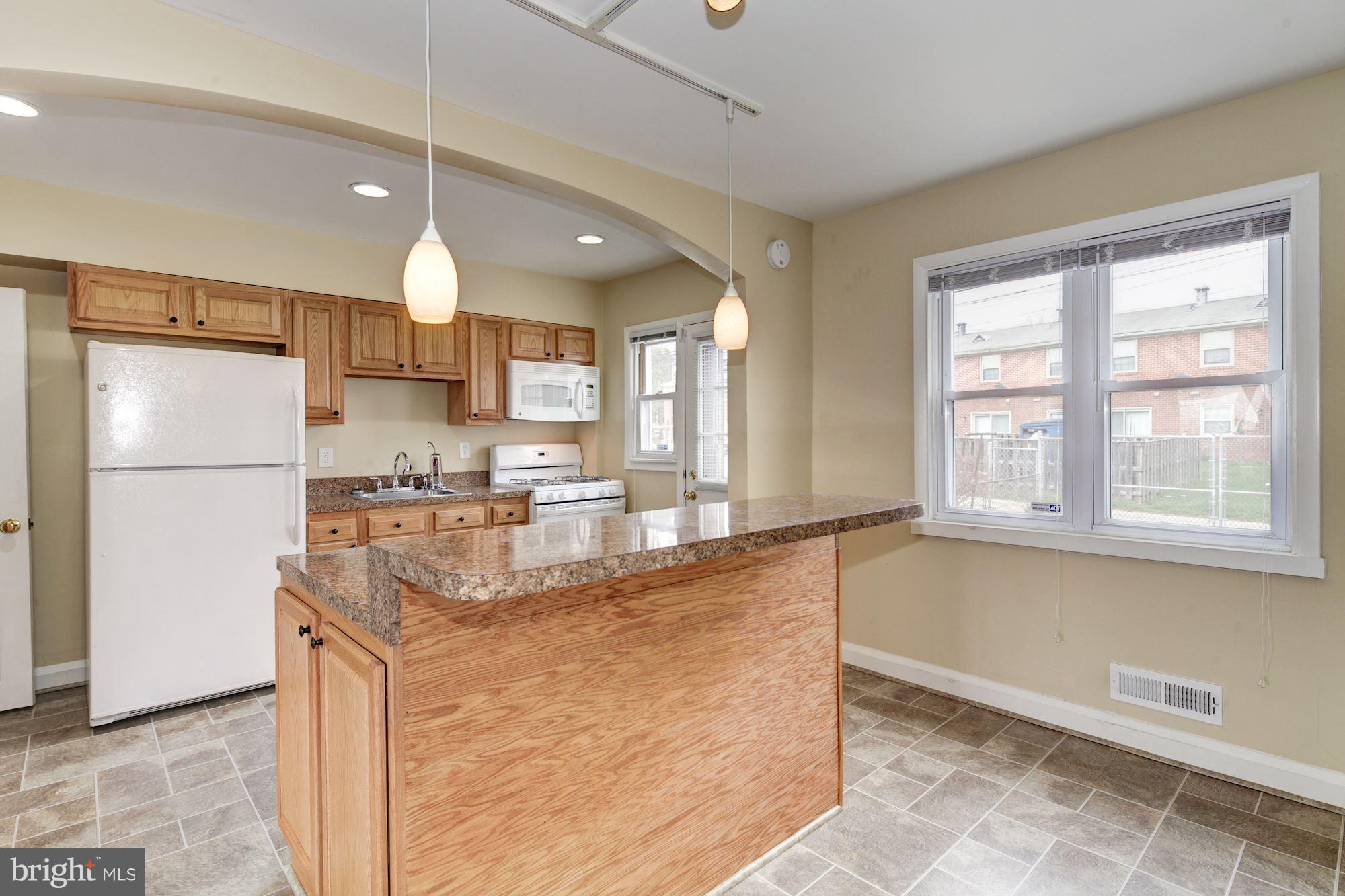 514 Queensgate Road Baltimore, MD 21229 - Photo 6 of 29 Kitchen, door to back entrance.