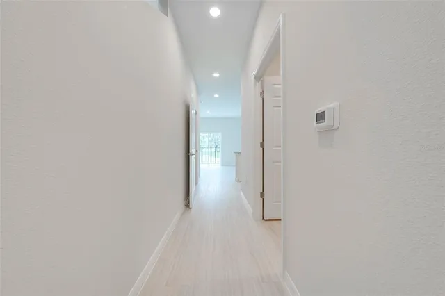 a view of a hallway with wooden floor