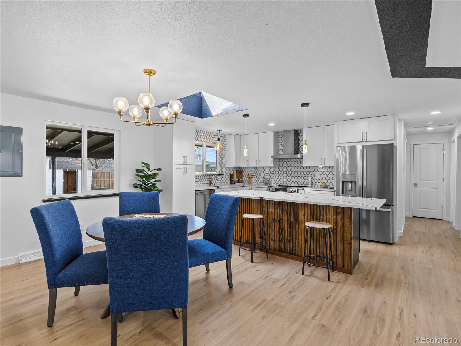 5673 Johnson Street Arvada, CO 80002 - Photo 12 of 40 a view of kitchen with granite countertop cabinets table and chairs