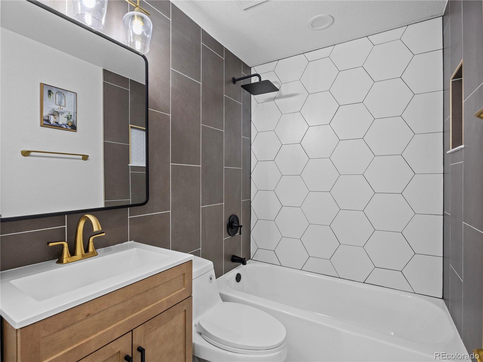 5673 Johnson Street Arvada, CO 80002 - Photo 26 of 40 a bathroom with a sink toilet and shower