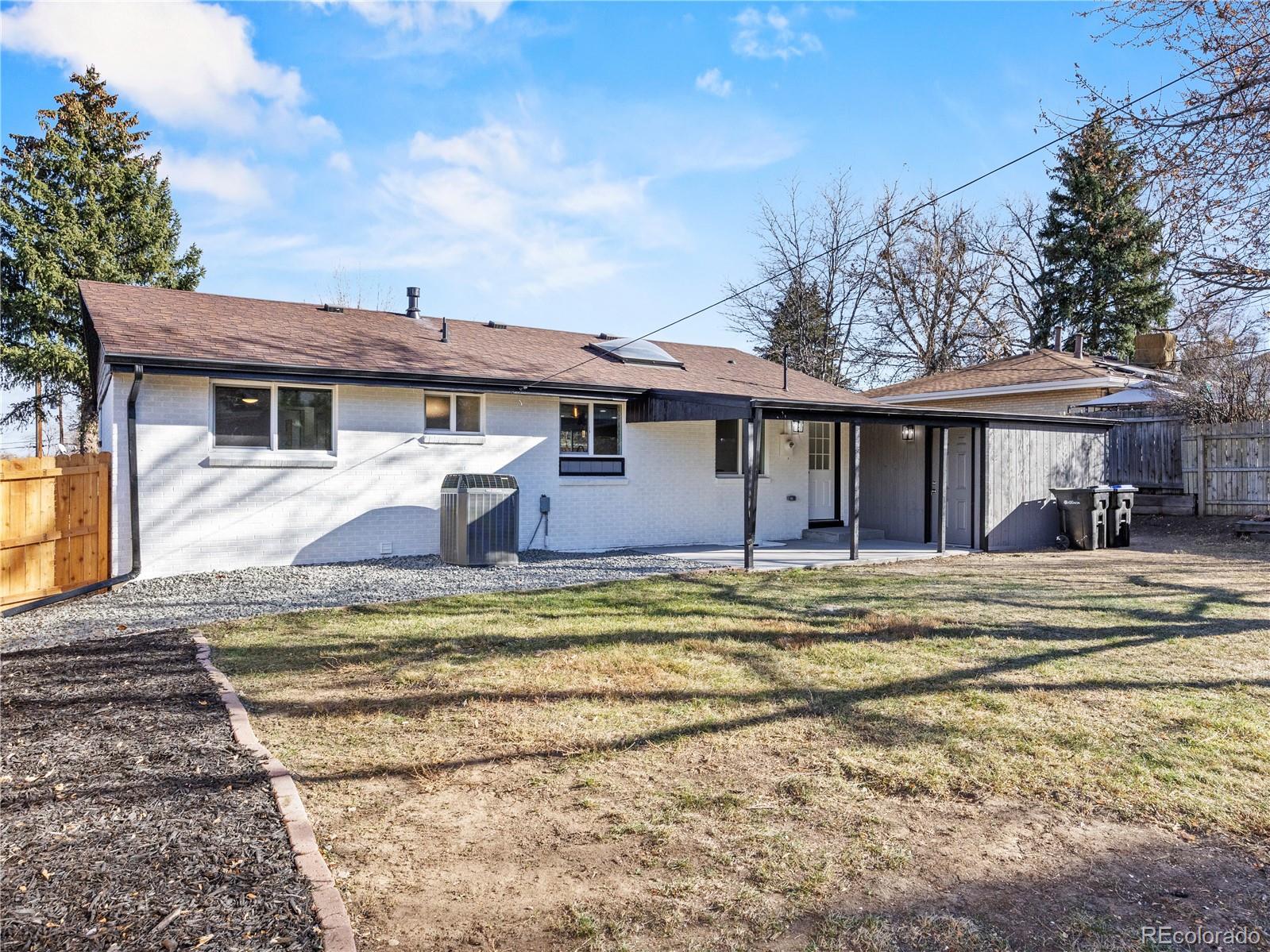 5673 Johnson Street Arvada, CO 80002 - Photo 37 of 40 a view of a dinning table and chairs in patio