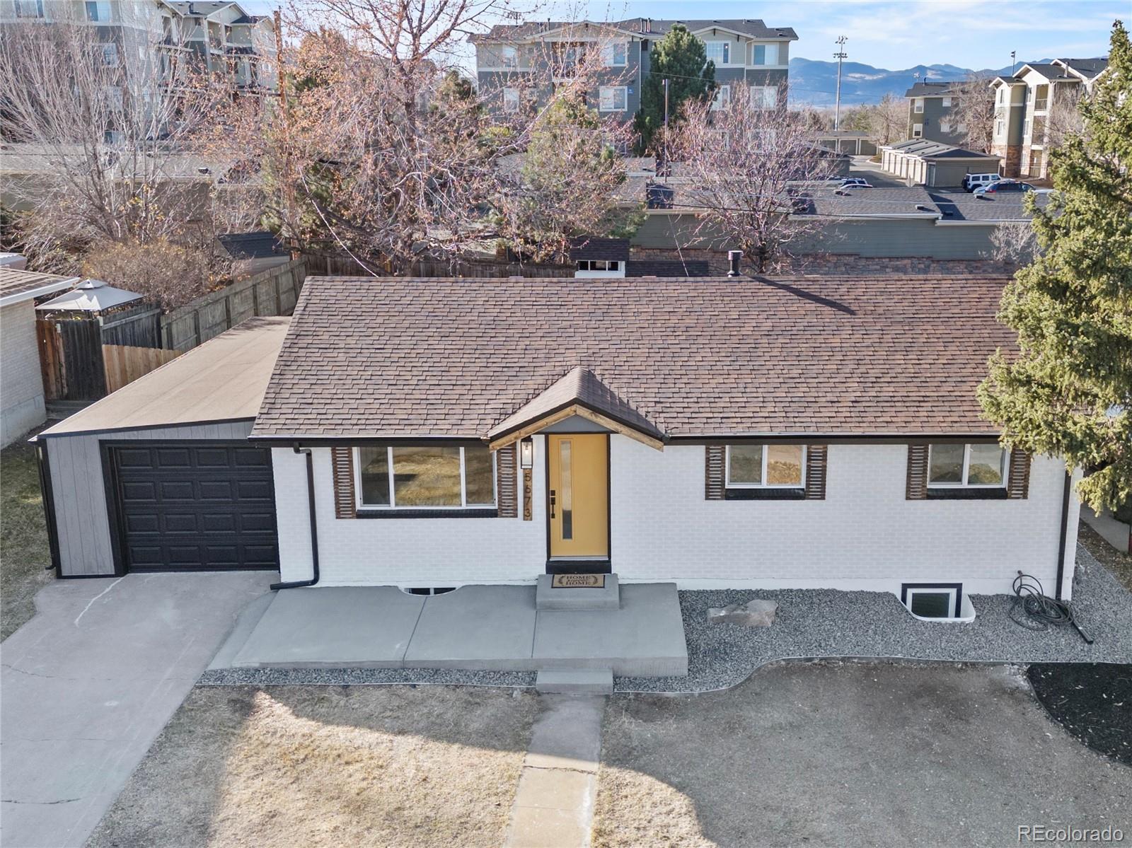 5673 Johnson Street Arvada, CO 80002 - Photo 39 of 40 a house that has a tree in front of it