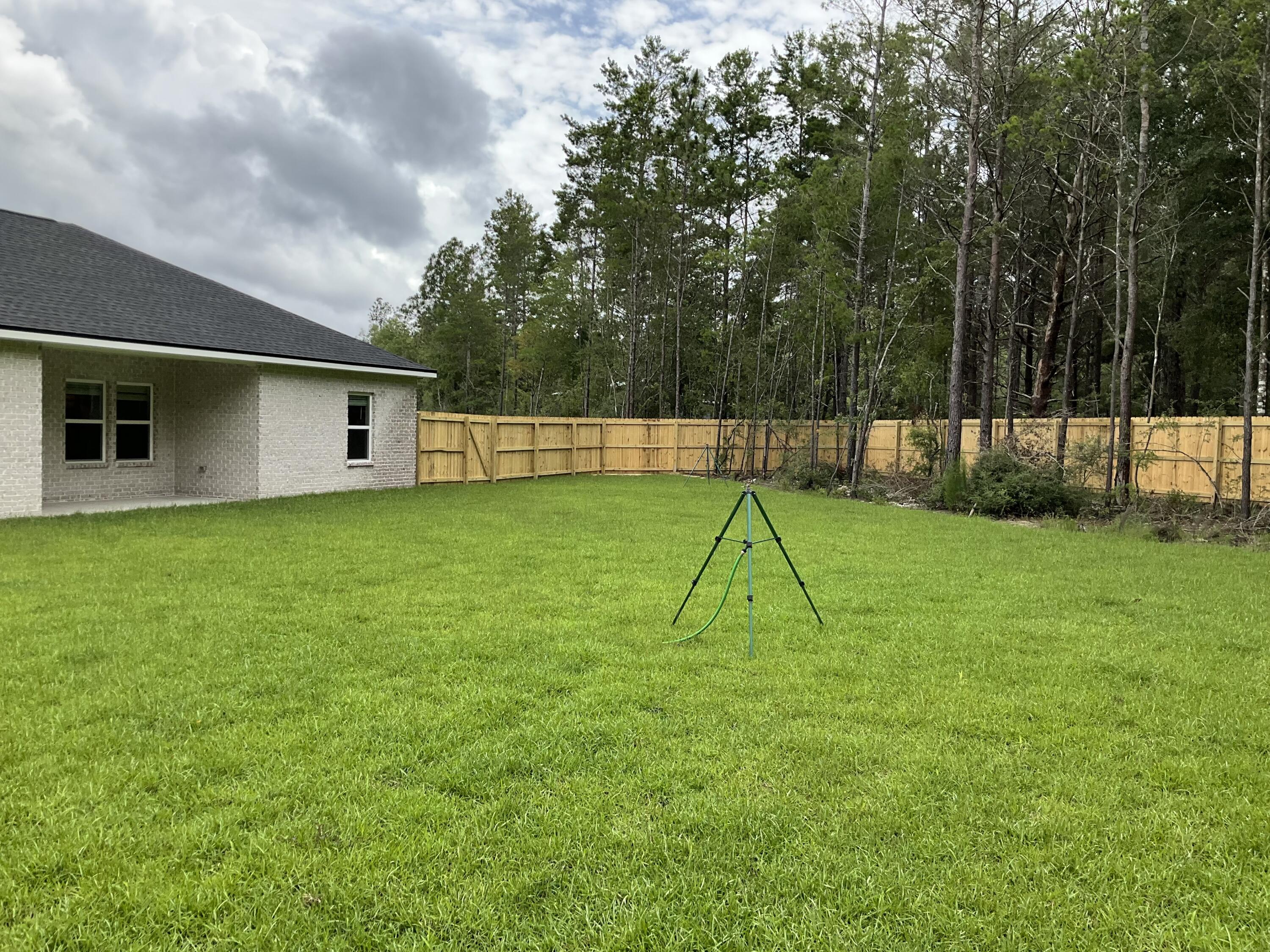 6120 Mildreds Way Crestview, FL 32539 - Photo 4 of 22 a view of a backyard with a slide
