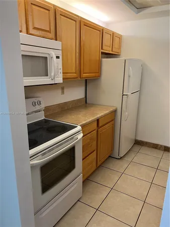 a kitchen with cabinets and appliances
