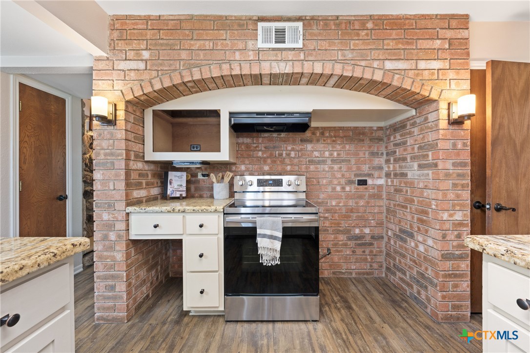 1903 North Harding Avenue Cameron, TX 76520 - Photo 7 of 44 a stove top oven sitting inside of a kitchen