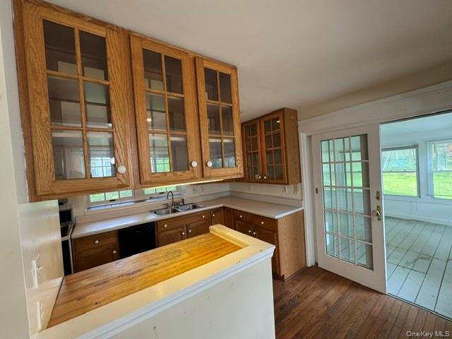 74 South Airmont Road Suffern, NY 10901 - Photo 17 of 42 Kitchen featuring wood cabinetry with glass-front upper cabinets, a double basin sink, and a wood-finish breakfast bar