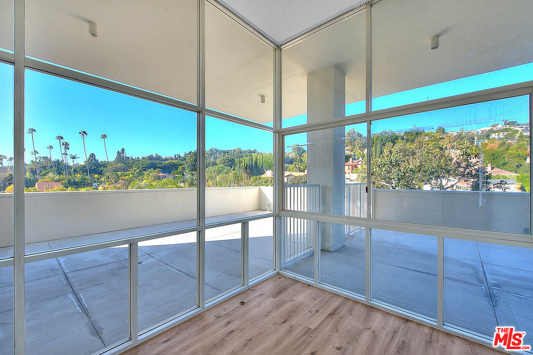 a view of a floor to ceiling window and wooden floor