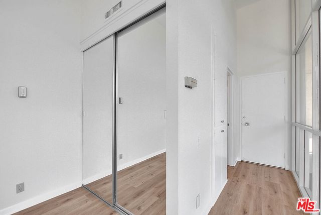 a view of hallway with wooden floor