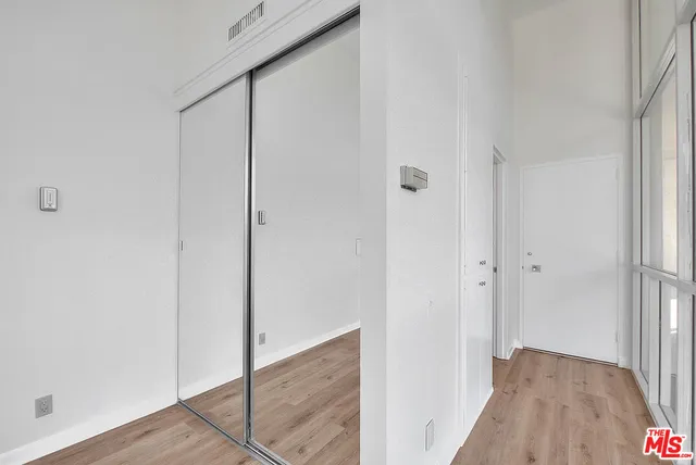 a view of hallway with wooden floor