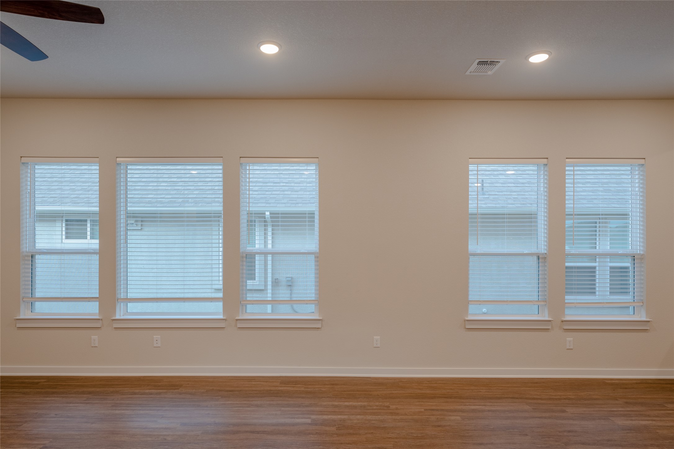 133 High Plains Drive Georgetown, TX 78628 - Photo 32 of 38 an empty room with wooden floor and windows