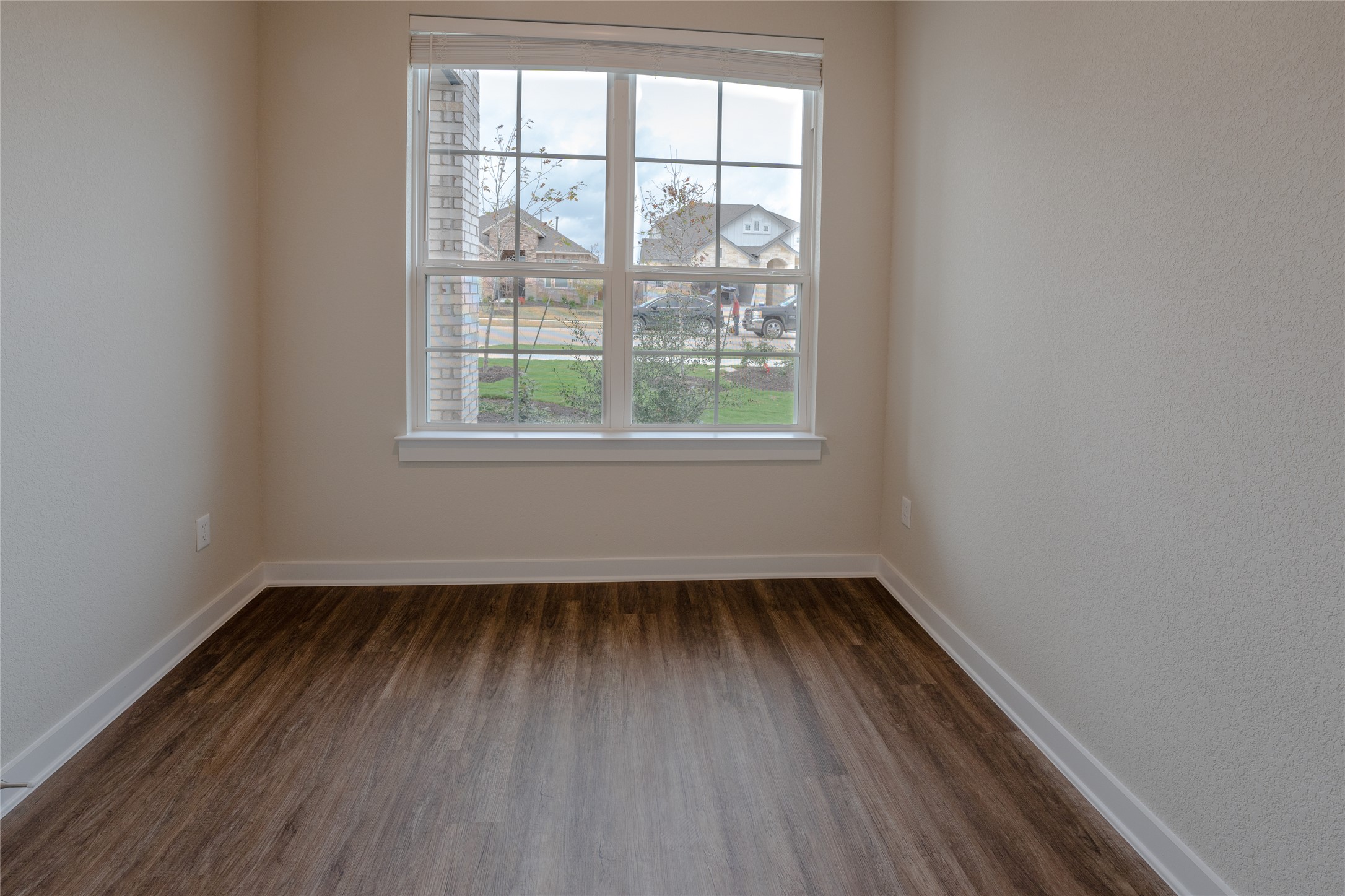 133 High Plains Drive Georgetown, TX 78628 - Photo 9 of 38 an empty room with wooden floor and windows
