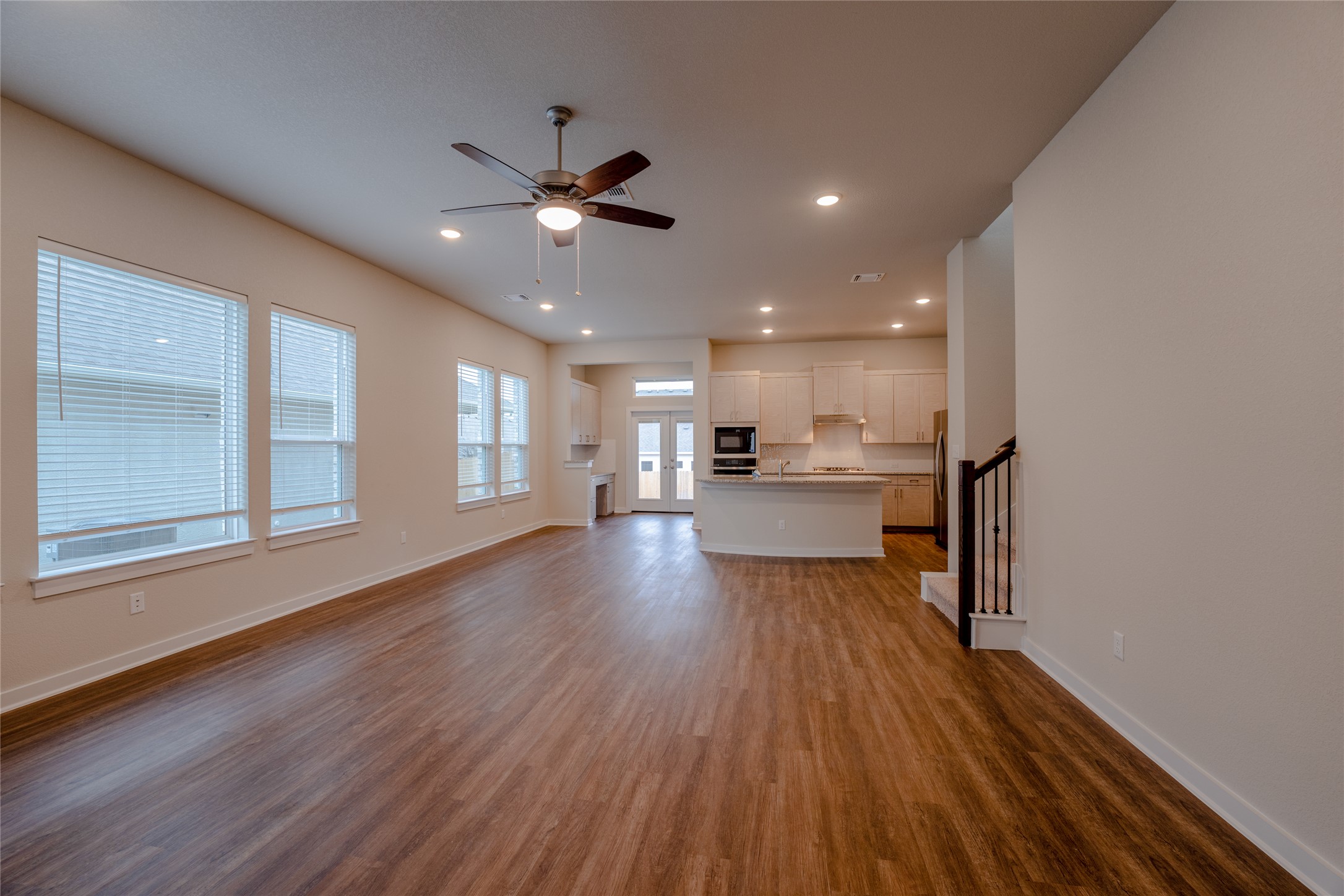 133 High Plains Drive Georgetown, TX 78628 - Photo 10 of 38 a view of a kitchen and an empty room with wooden floor and a window