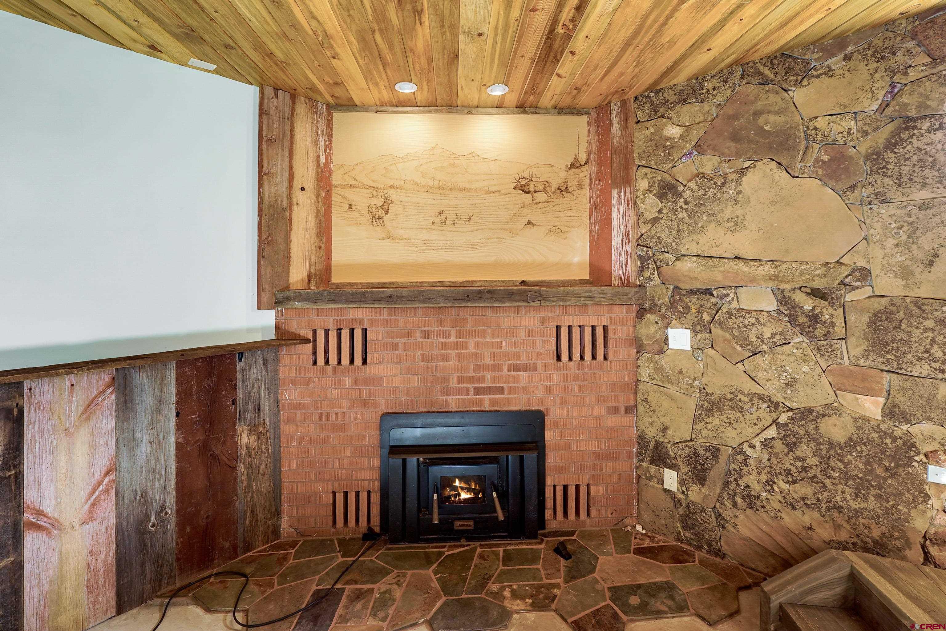 4462 County Road 124 Durango, CO 81301 - Photo 25 of 44 a living room with a fireplace