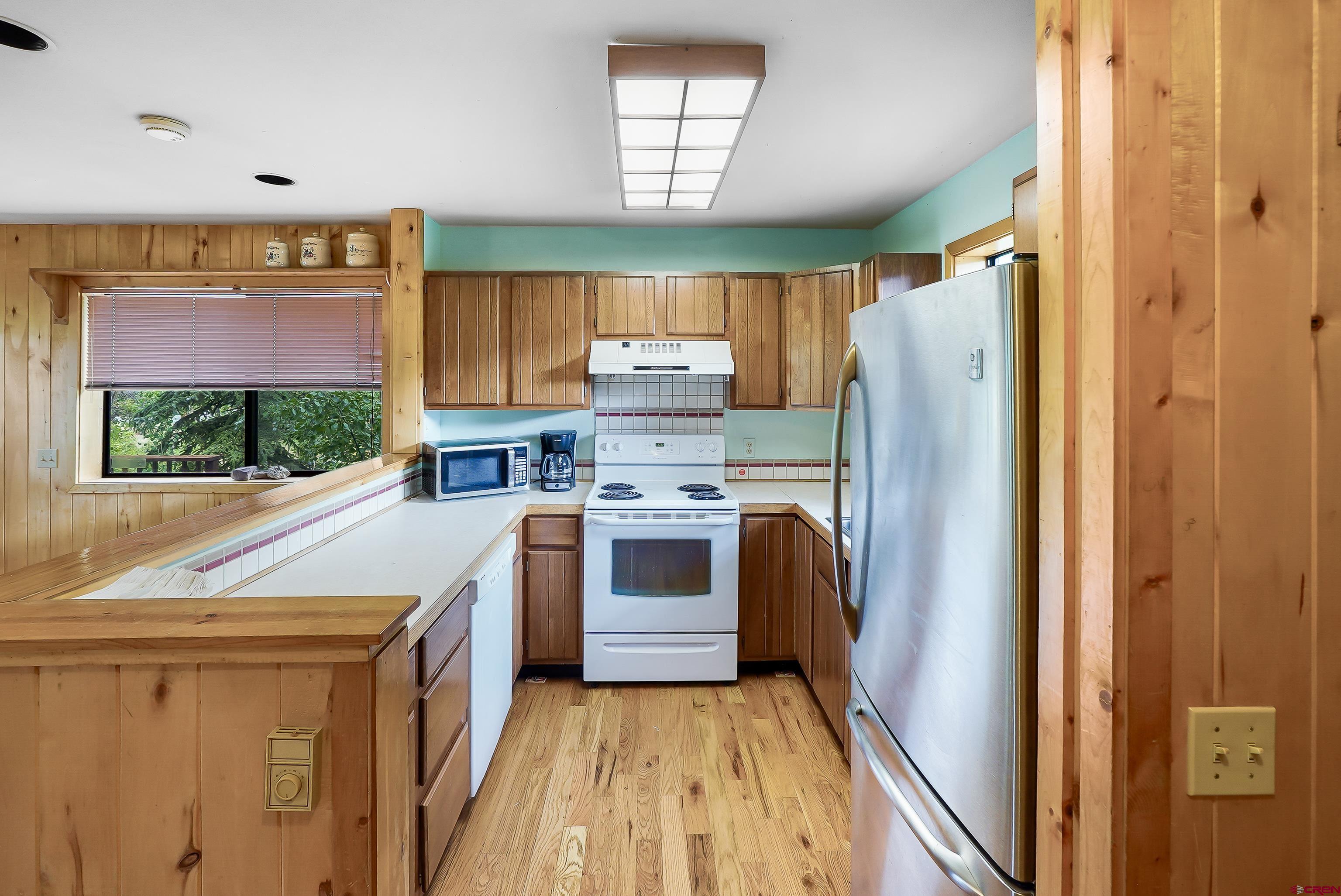 4462 County Road 124 Durango, CO 81301 - Photo 42 of 44 a kitchen with a refrigerator a stove a washer and dryer