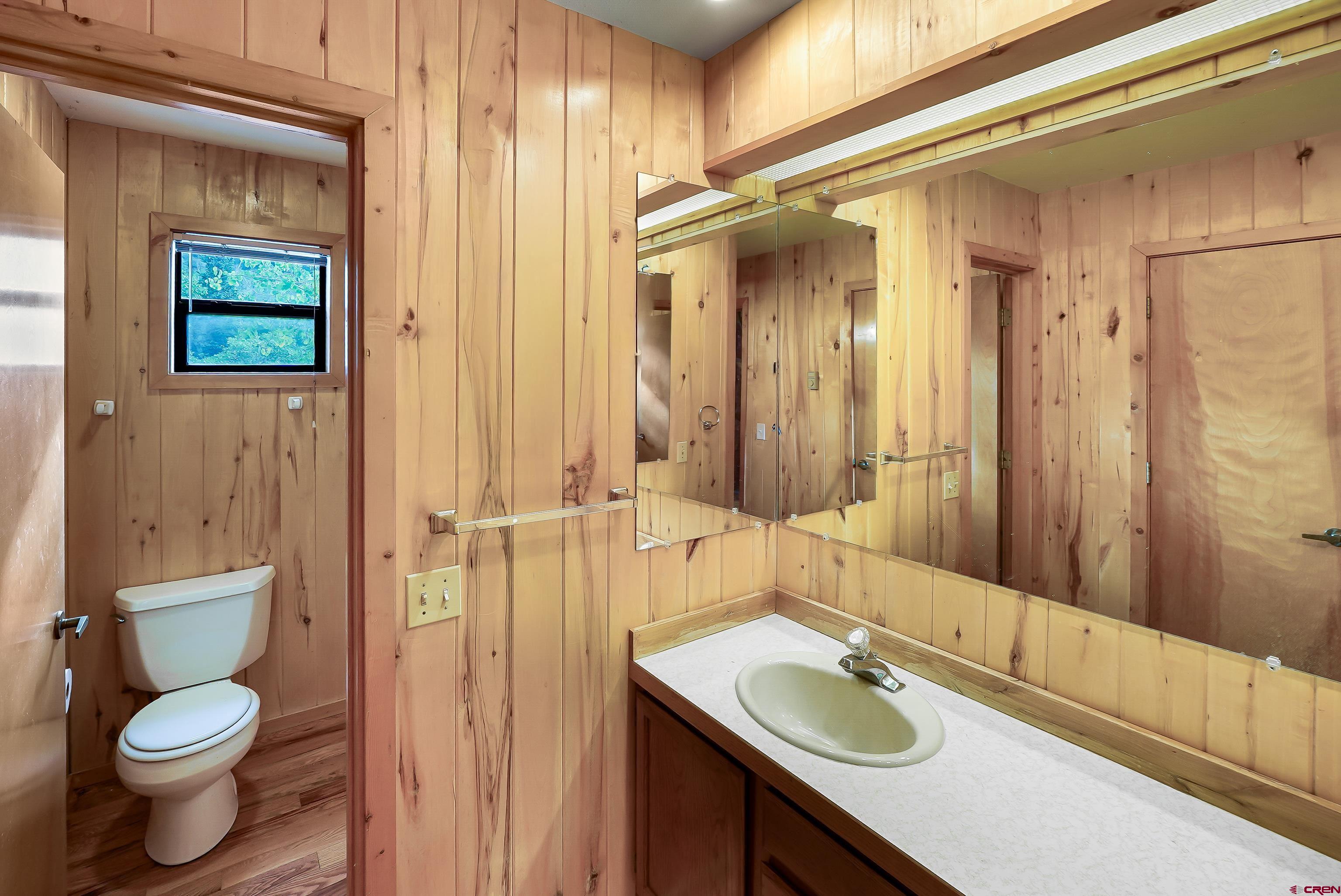 4462 County Road 124 Durango, CO 81301 - Photo 44 of 44 a bathroom with a granite countertop toilet sink and mirror