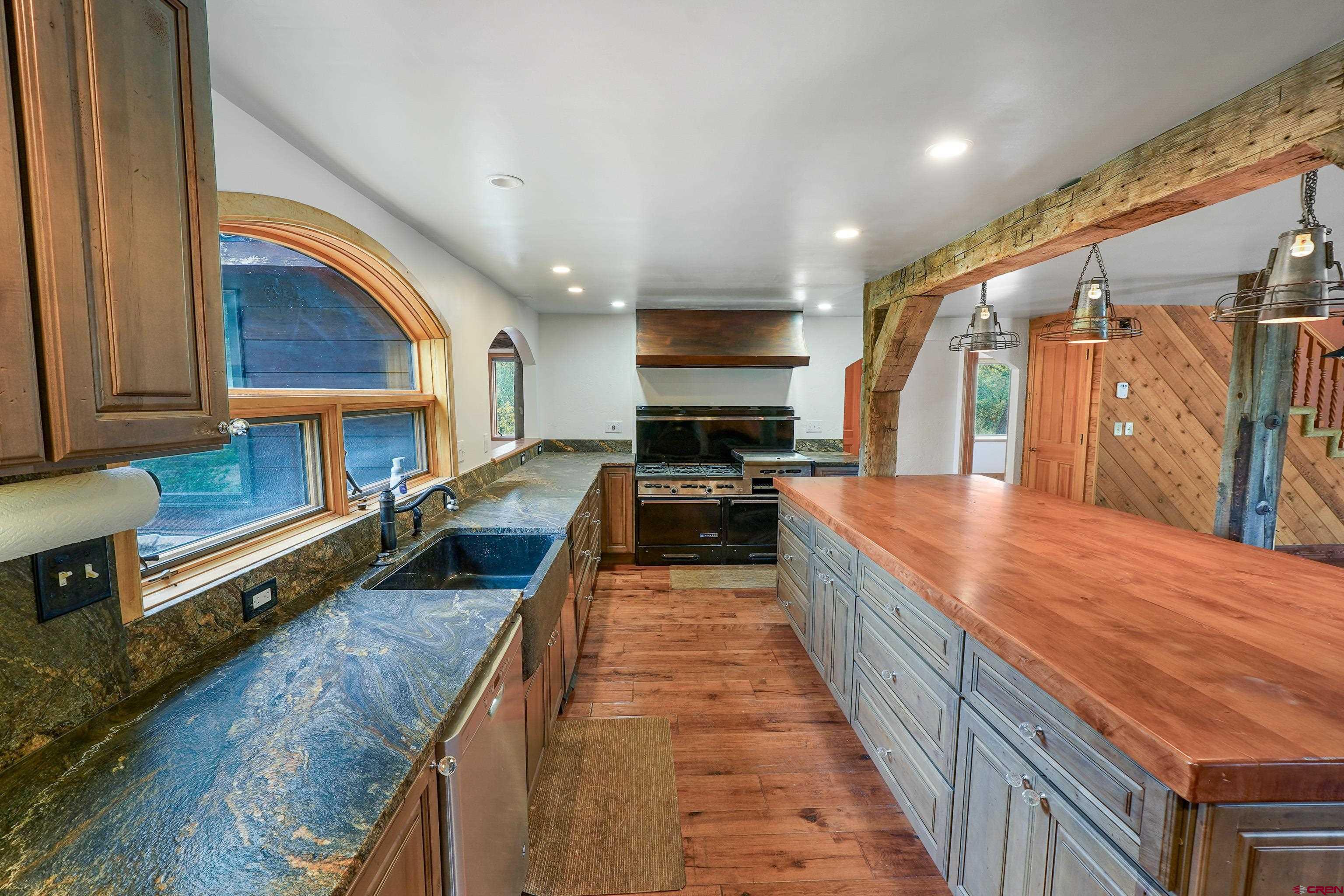 4462 County Road 124 Durango, CO 81301 - Photo 7 of 44 a large kitchen with stainless steel appliances granite countertop a large counter top a stove and a refrigerator